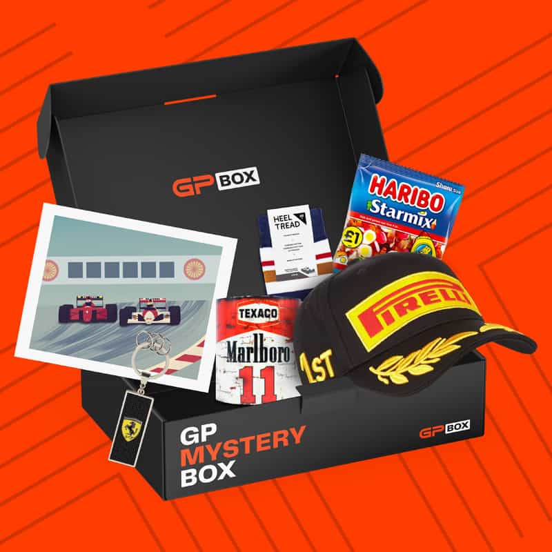 A subscription box with a F1 theme open with many racing themed products