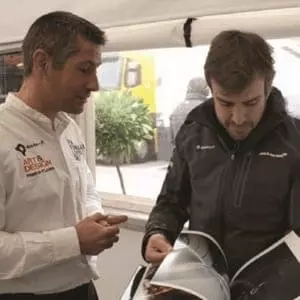 Marko F1 seller testimonial showing his design book to Fernando Alonso